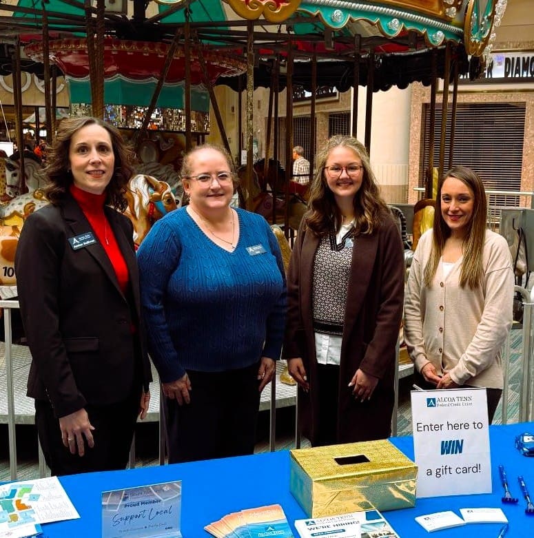 Four ATFCU employees stand behind a table at the job fair