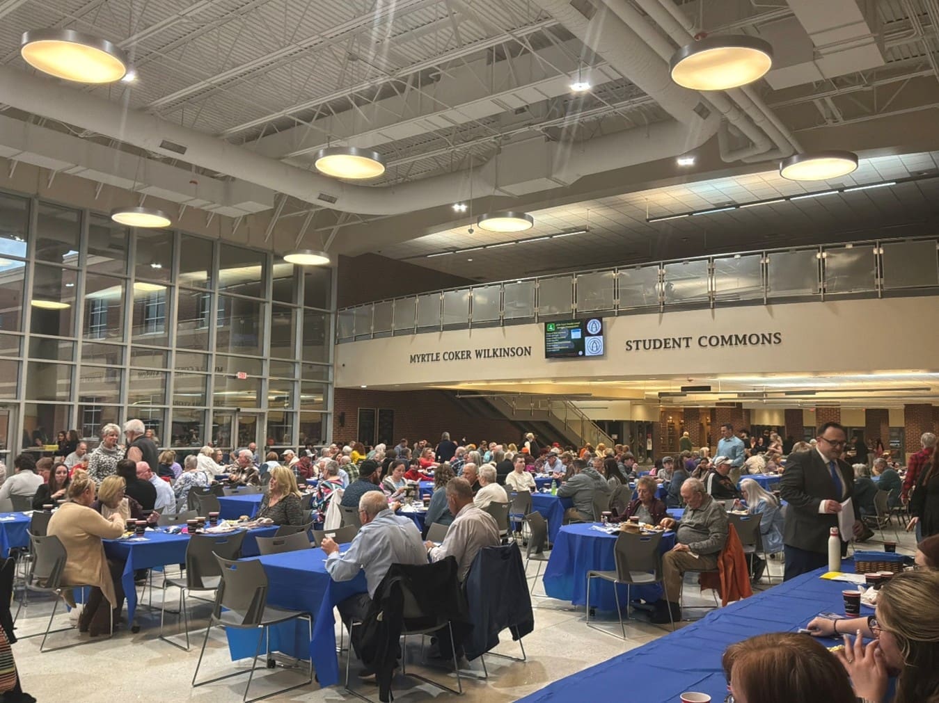 Photo of a room filled with attendees of the annual meeting seated at tables