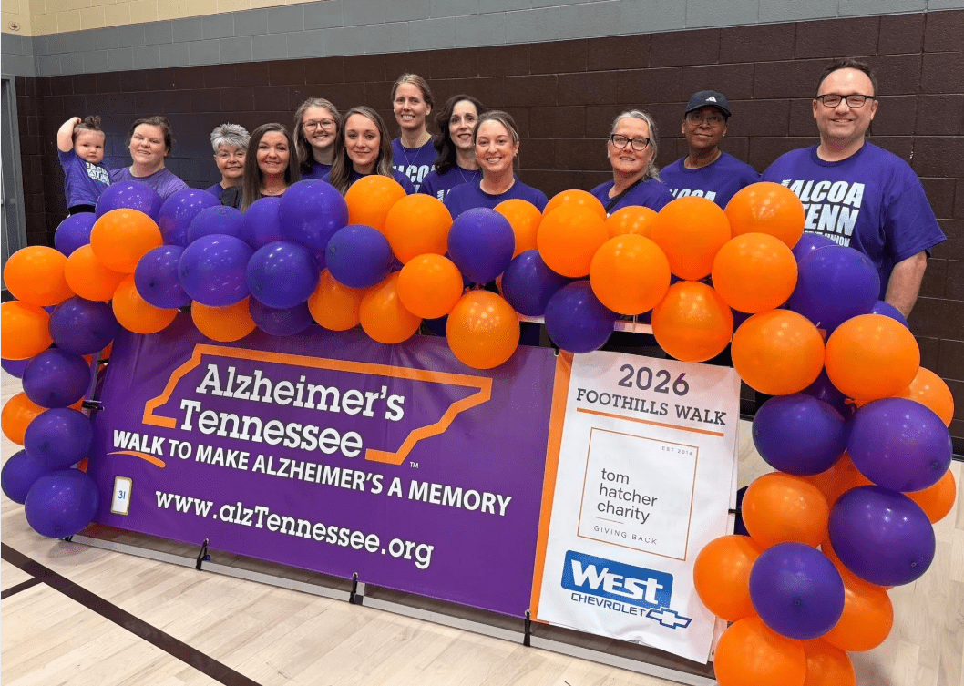 Group of volunteers in a gym in front of a Alzheimer's sign