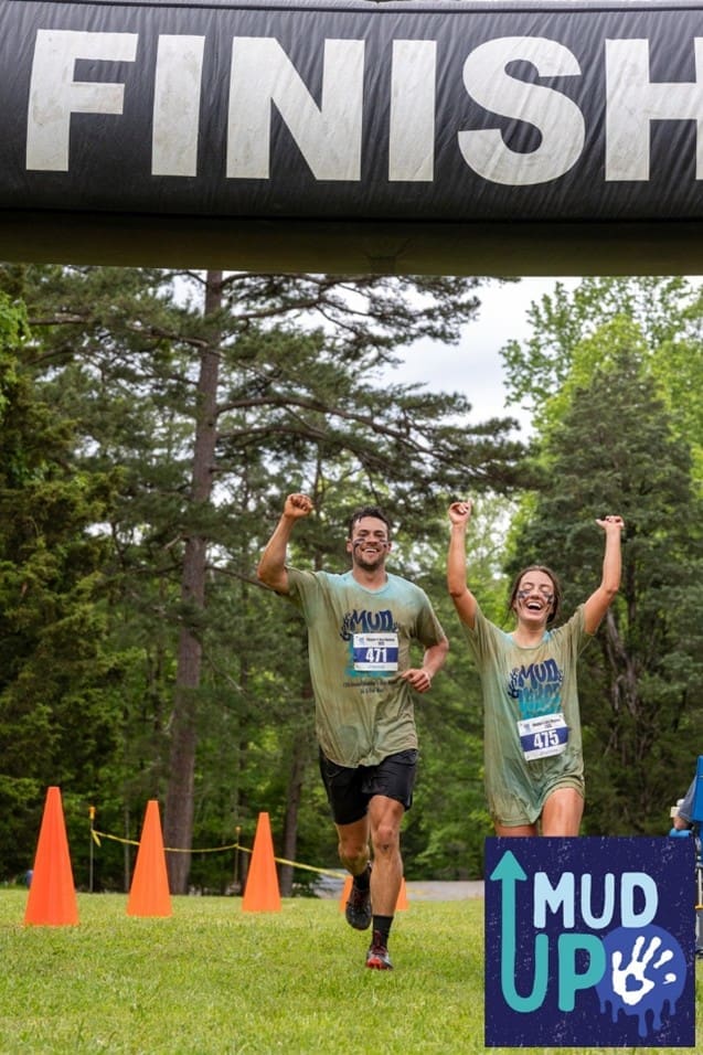 Two runners cross a finish line