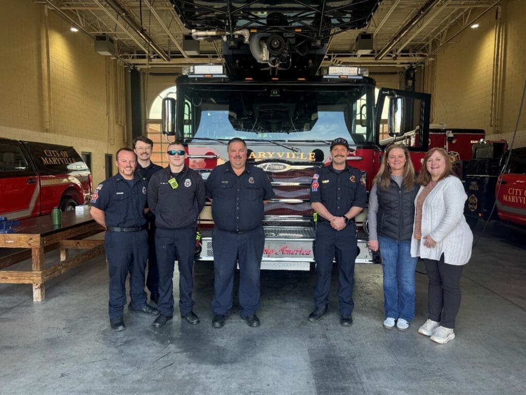 Marysville Fire Department and ATFCU employees pose in front of a fire engine