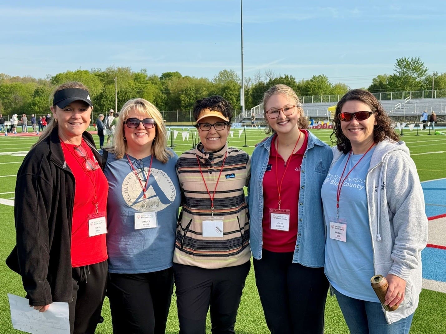 Five ATFCU employees pose together outside at the Special Olympics