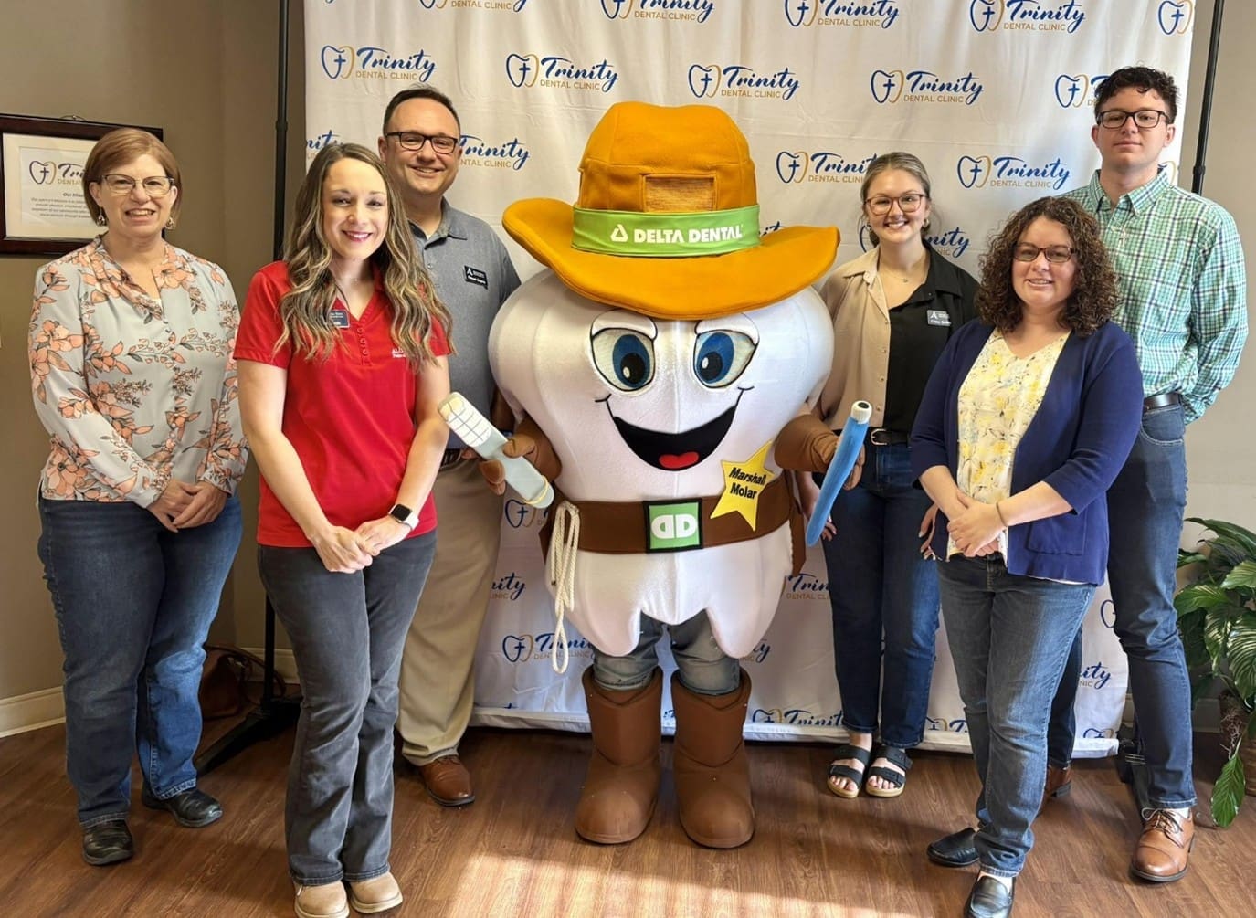 Alcoa Team poses with a giant tooth mascot at Trinity Dental
